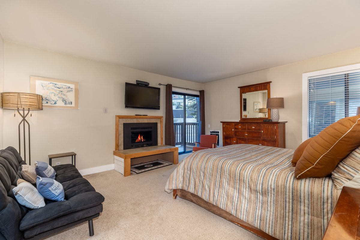 Master bedroom with fireplace and TV