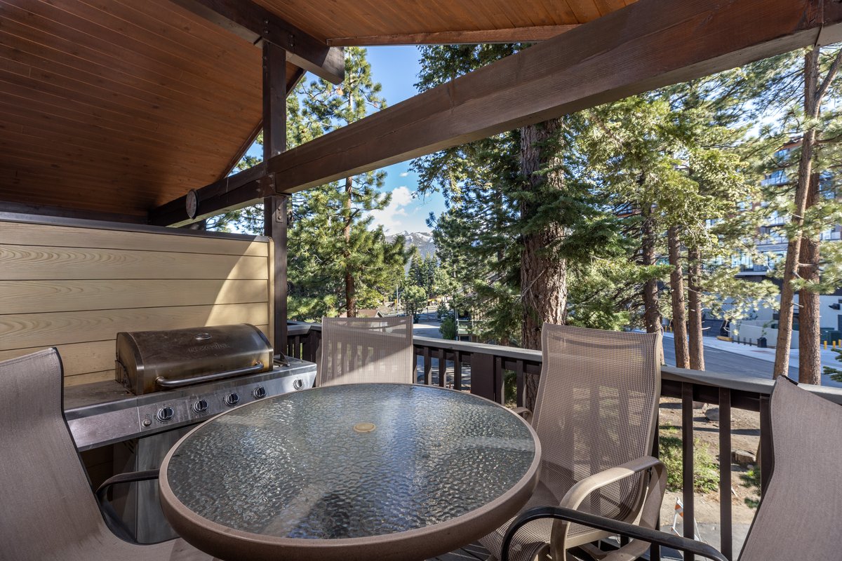 Private balcony with bistro seating and forest views
