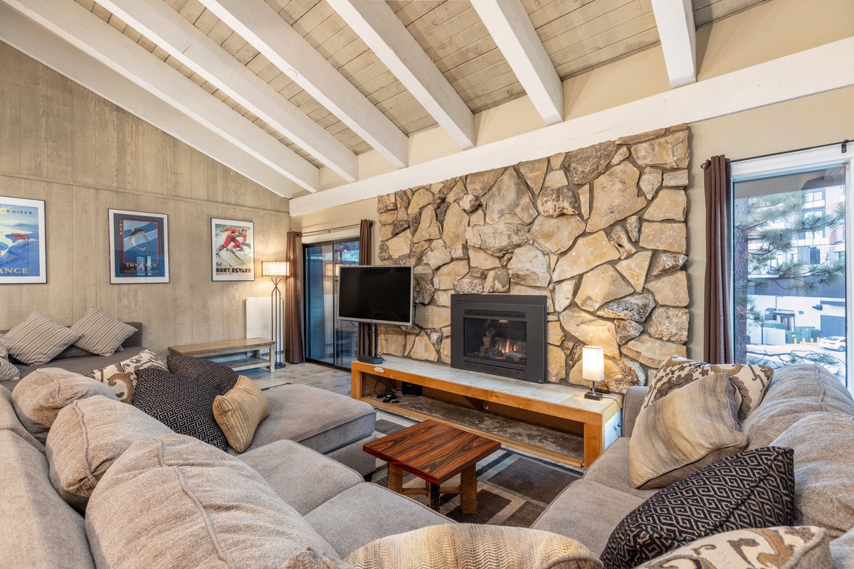 Great room with stone fireplace and ski posters